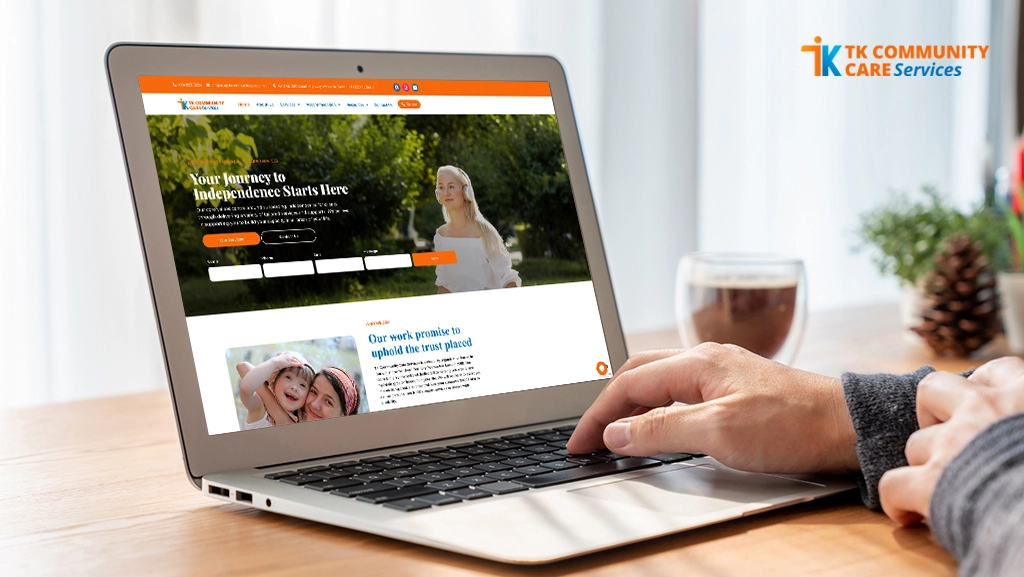 Person browsing TK Community Care's website on a laptop, showcasing the homepage with the title "Your Journey to Independence Starts Here" – a real-world example of NDIS SEO success with 905% organic growth for TK Community Care. Perfect case study for SEO for NDIS providers.